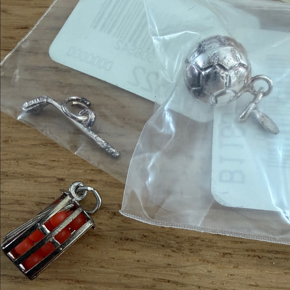 Silver Soccer Ball , field hockey stick and ball, and crate if oranges CHARMS